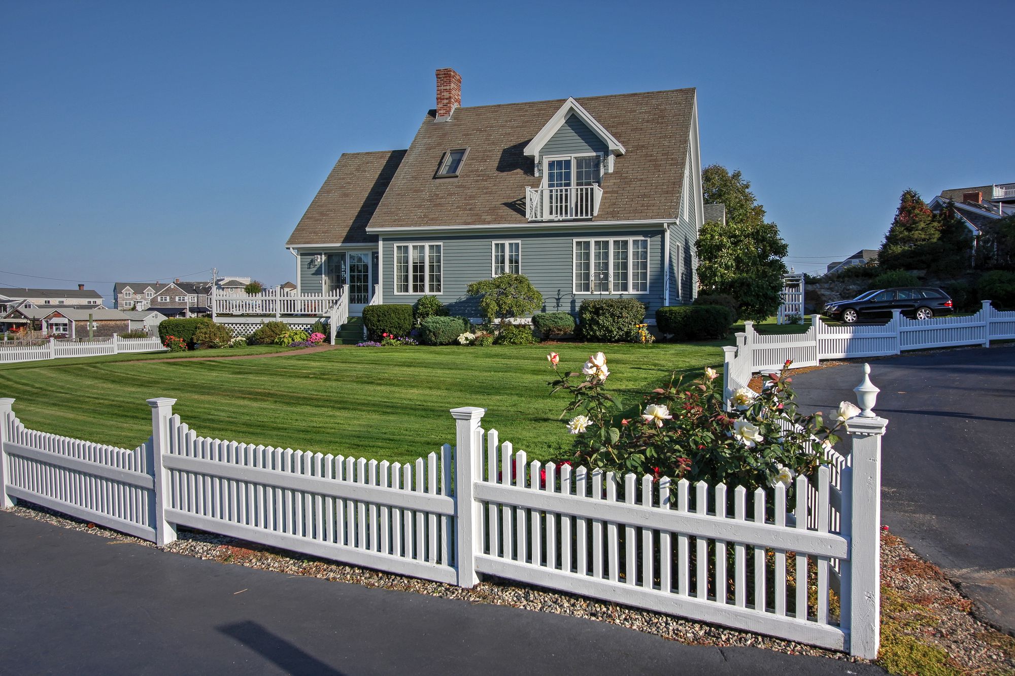 White picket fence around a classic home