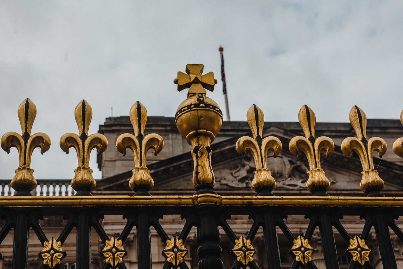 Black and gold ornamental iron fence with decorative finials