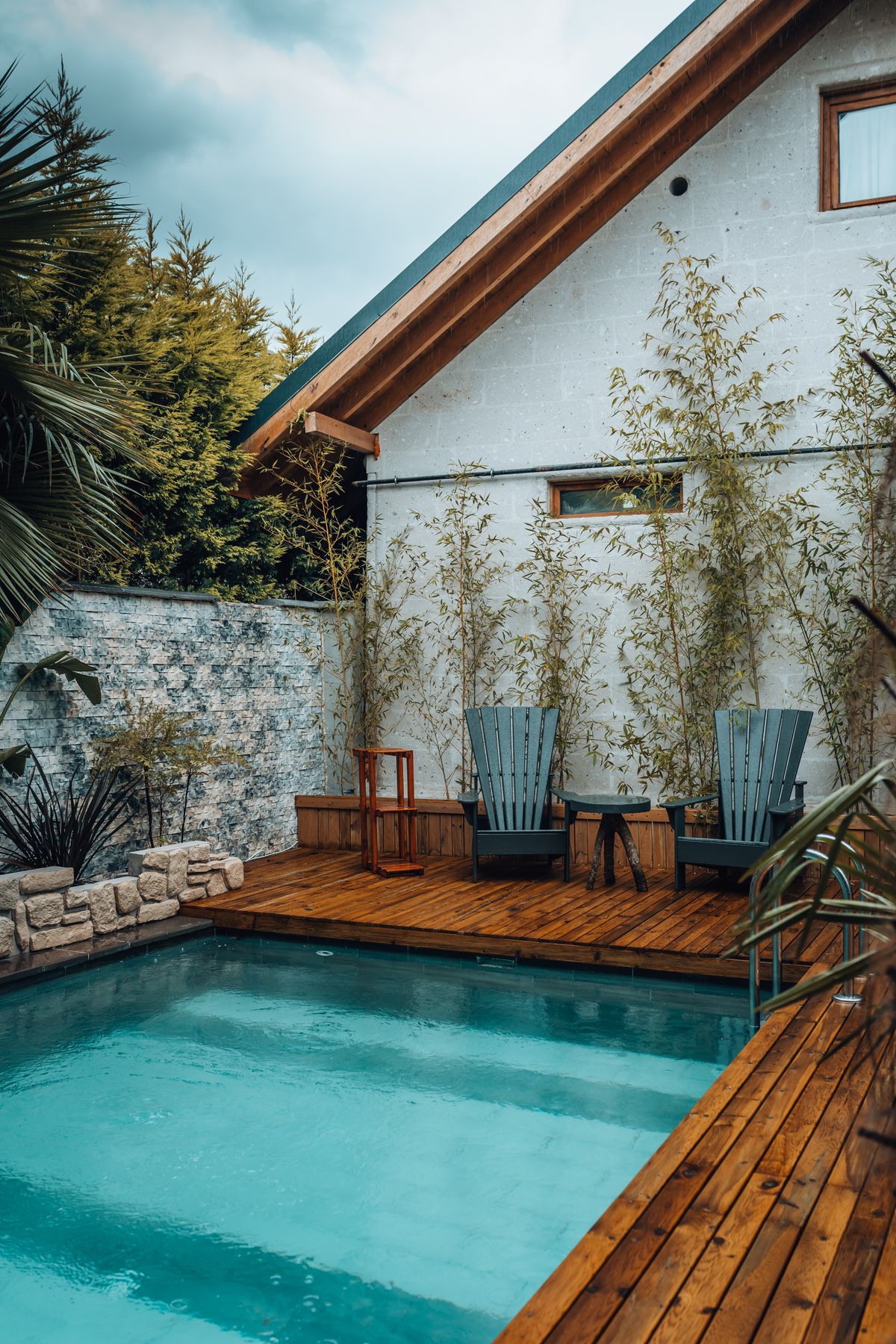 Hardwood pool deck beside a modern home